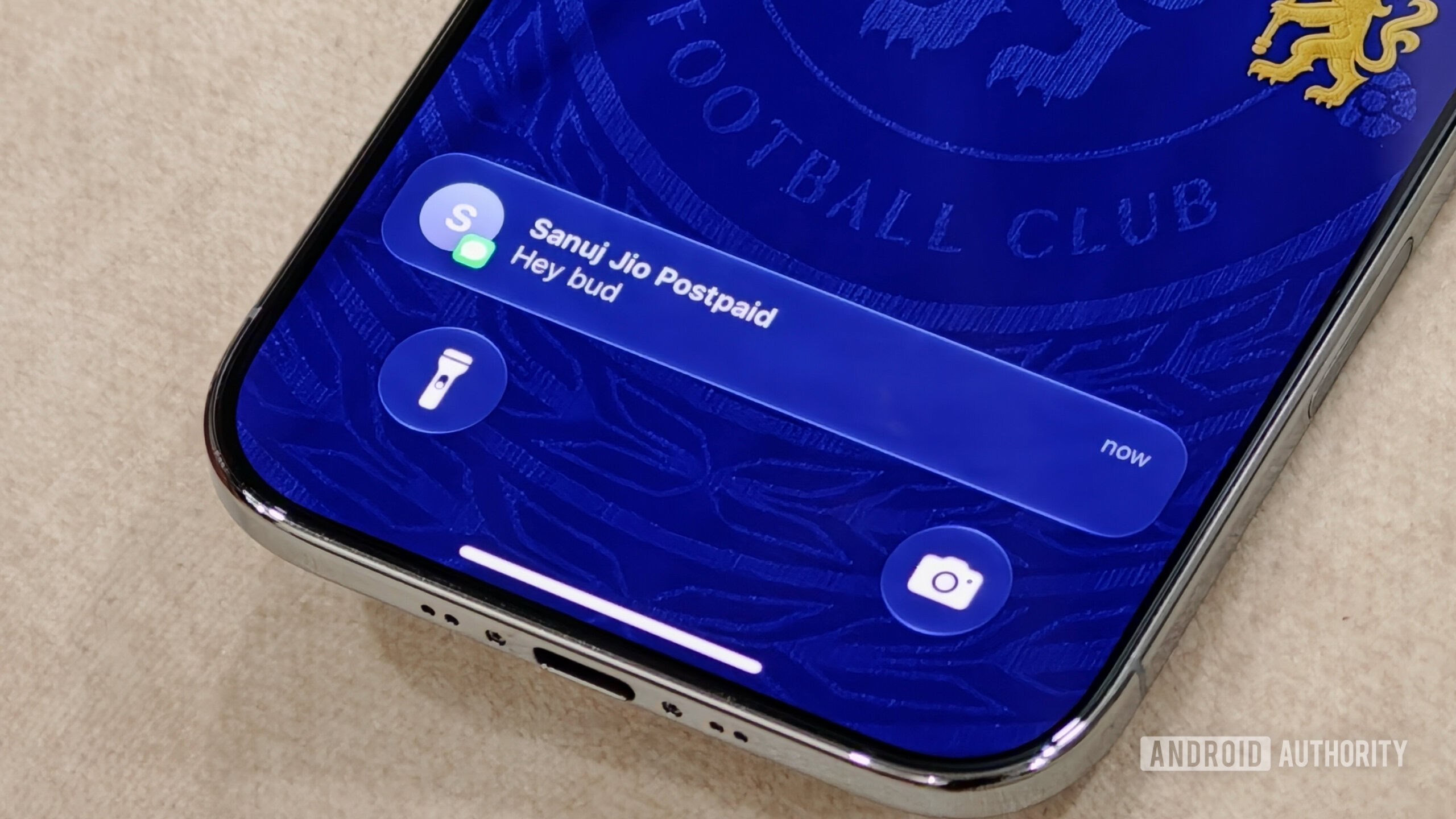 ios messages sync Close-up of an iPhone lock screen displaying an incoming iMessage text notification banner