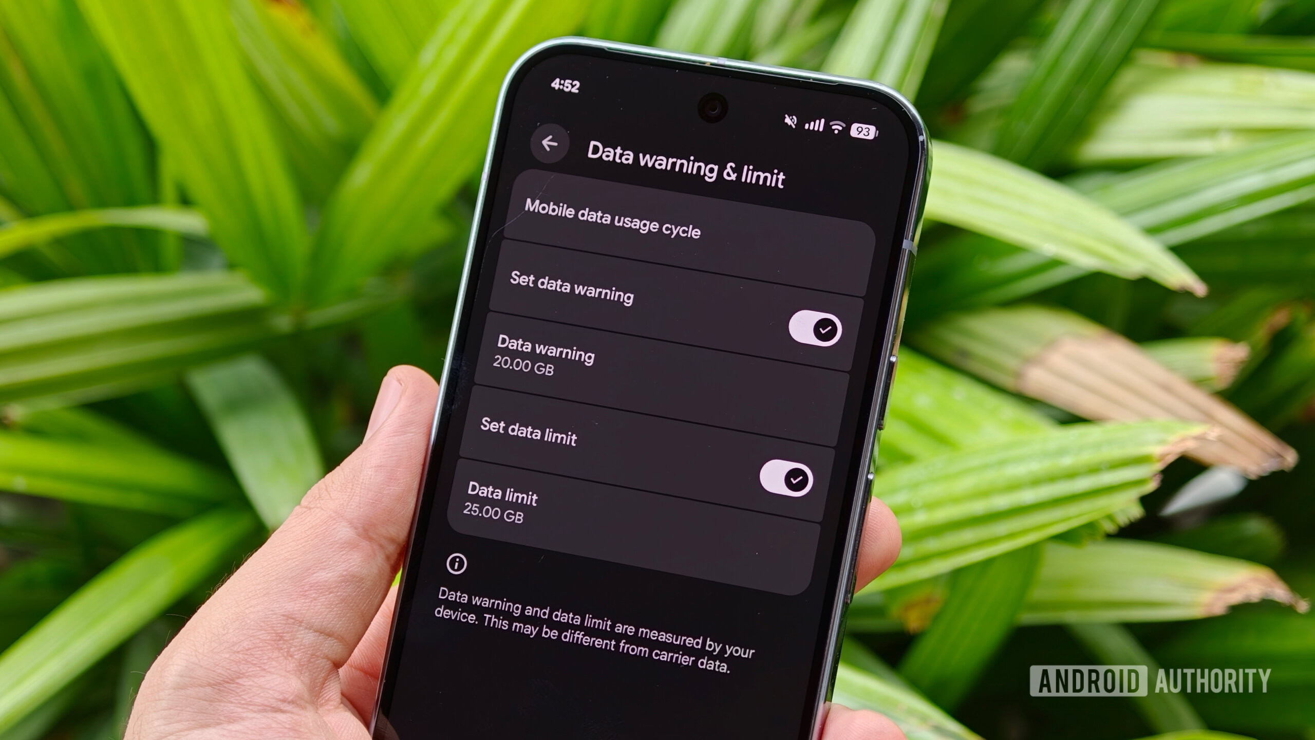 mobile data settings 2 A hand holding a smartphone showcasing the "Data warning & limit" settings page with toggles enabled for specific gigabyte thresholds