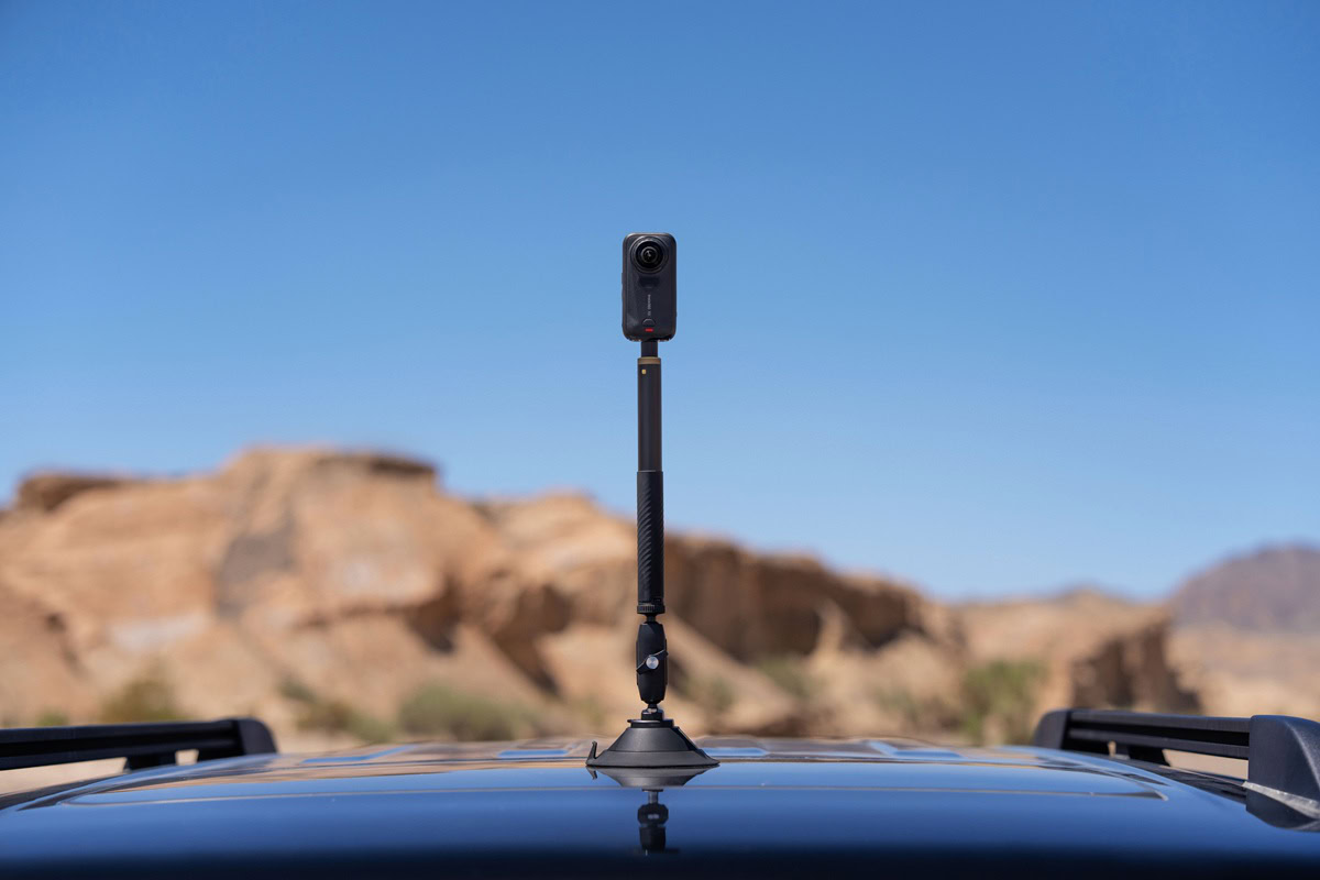 Insta360 X6 camera attached to a suction cup car mount in a desert landscape. Insta360-X6-camera-attached-to-a-suction-cup-car-mount-in-a-desert-landscape