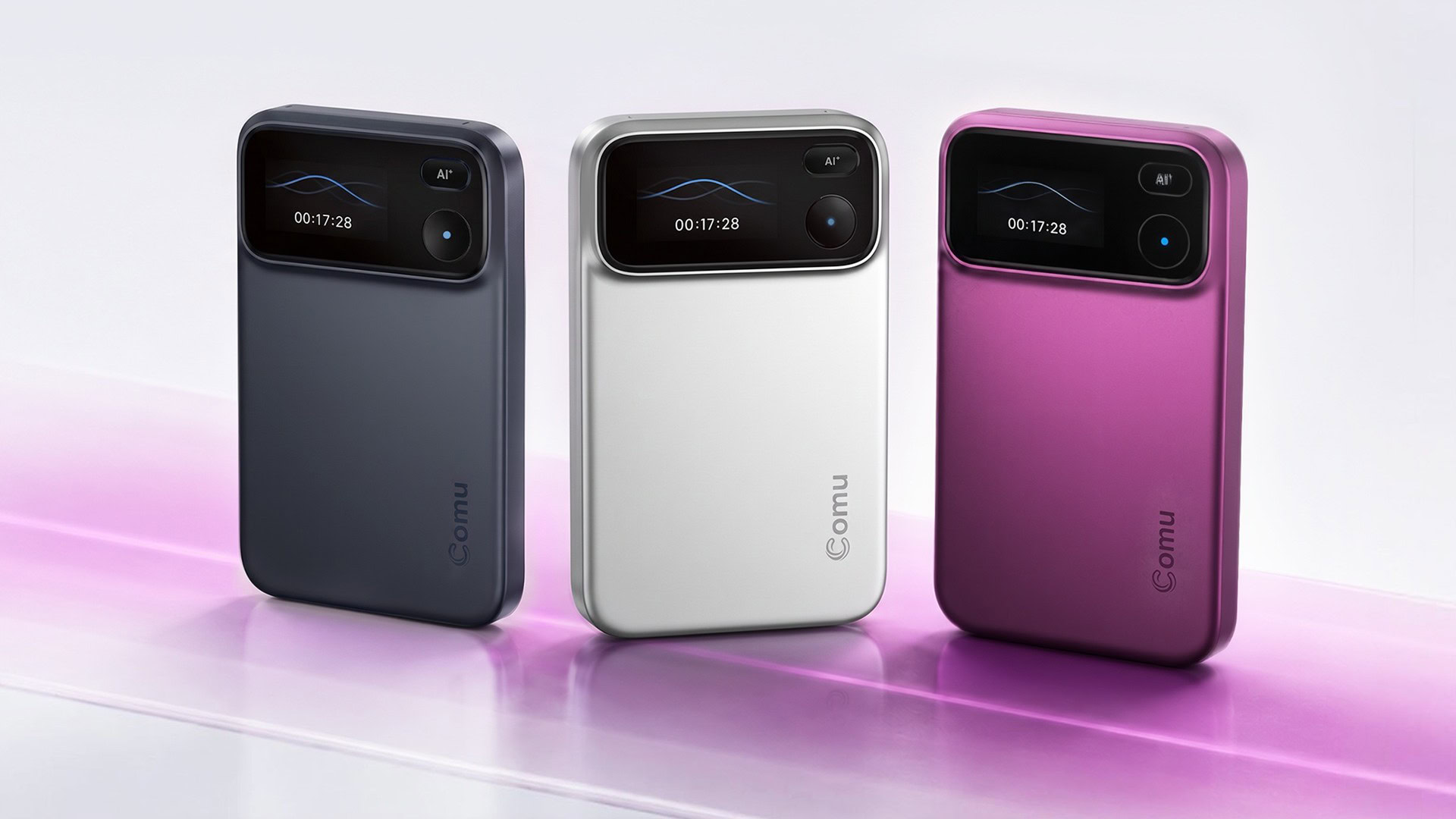 Comu Action Pro in charcoal grey, silver, and magenta Three-Comu-Action-Pro-AI-recorder-devices-lined-up-in-charcoal-grey-silver-and-magenta-showing-front-display-screens-and-AI-buttons