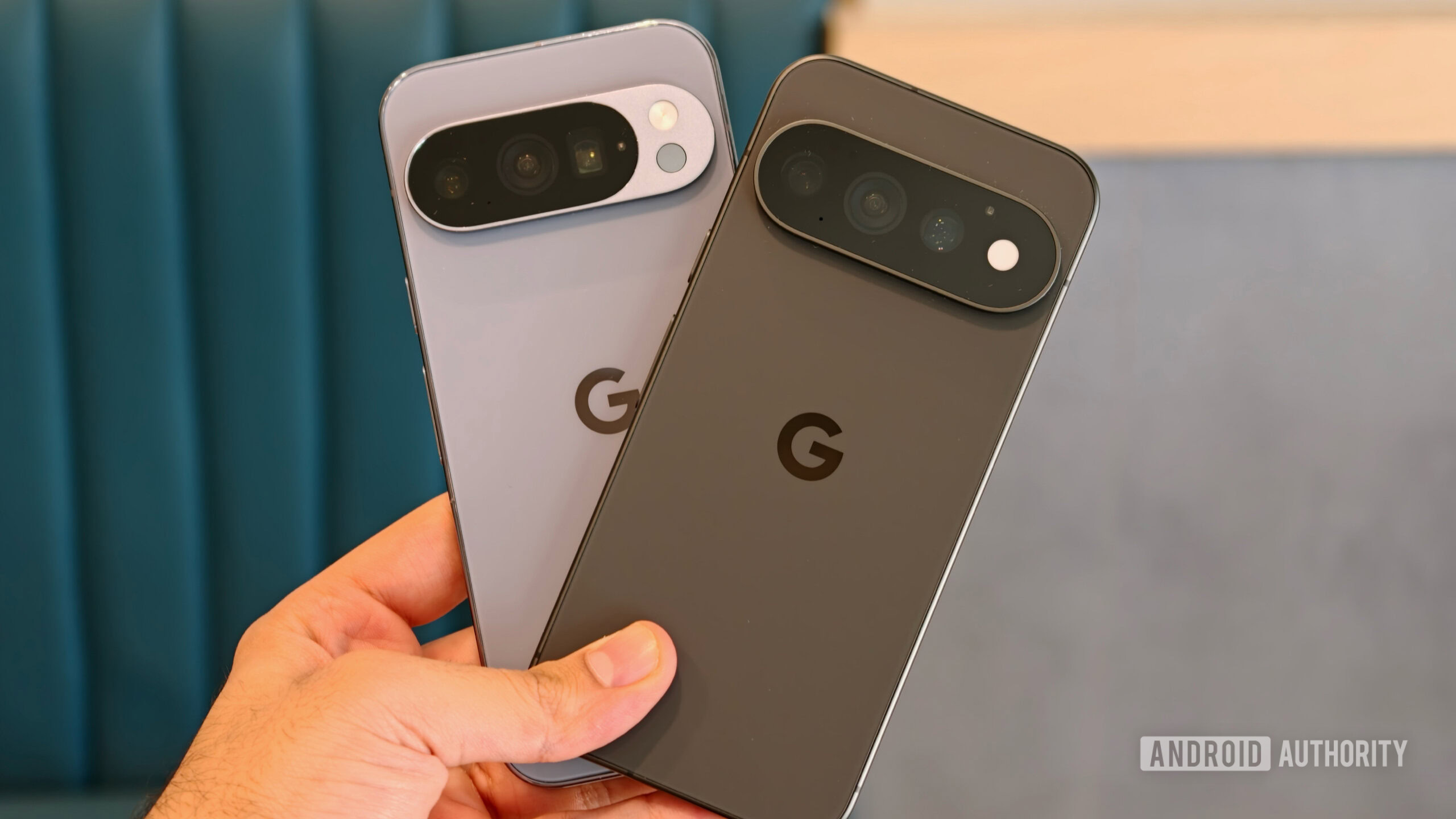 pixel 11 pro vs pixel 10 pro modem 1 A hand holding Pixel 11 Pro and Pixel 10 Pro side-by-side to compare camera visors and rear panel designs