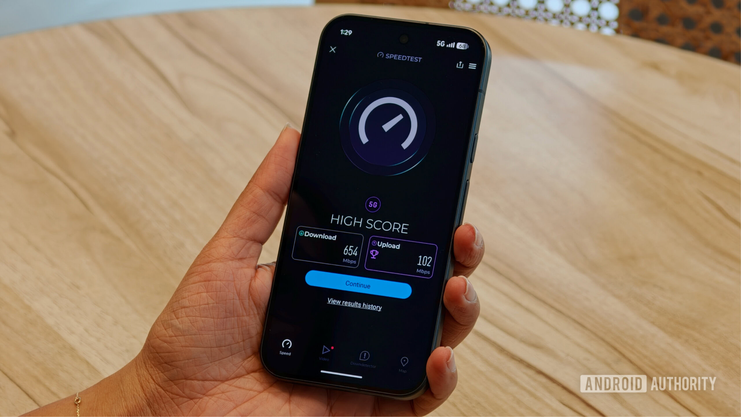 pixel 11 pro vs pixel 10 pro modem 6 Pixel 11 Pro running the Speedtest app displaying a 5G high score of 654 Mbps download and 102 Mbps upload