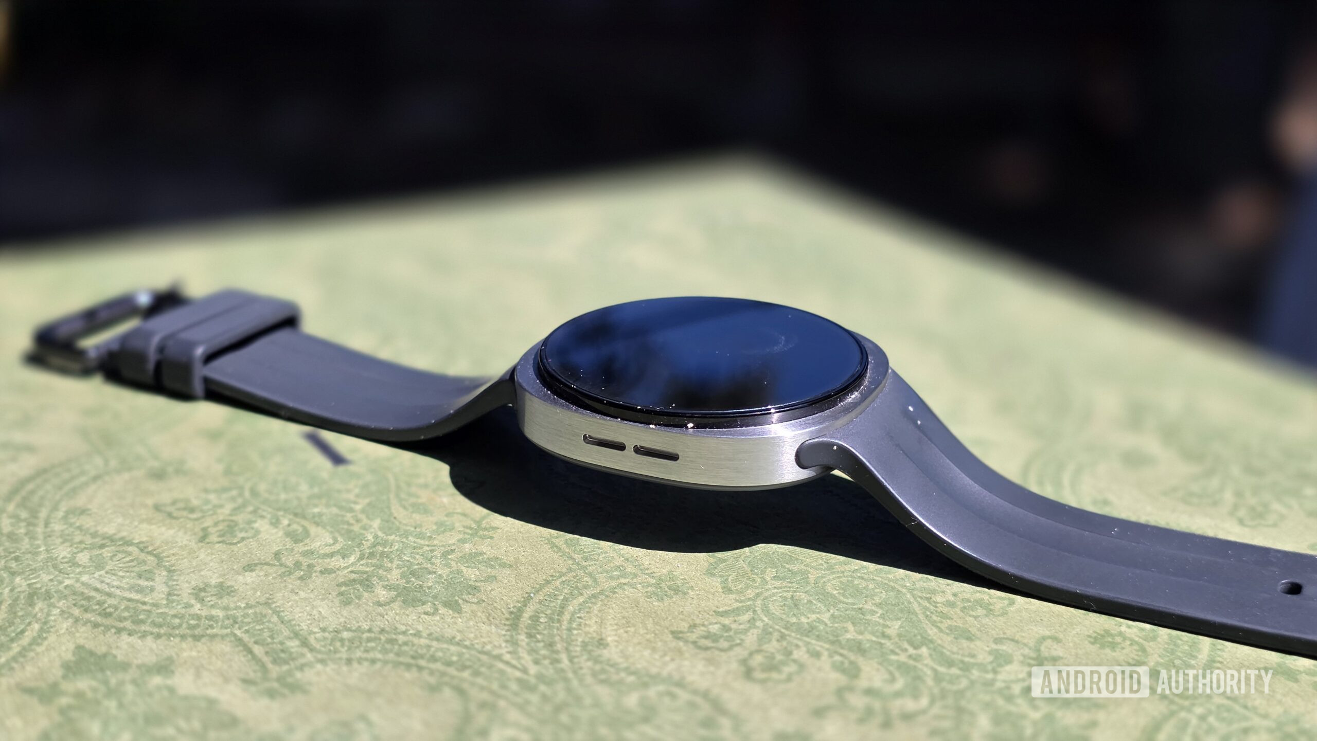 Samsung Galaxy Watch 9 review showing the left side of the watch with the speaker grille visible