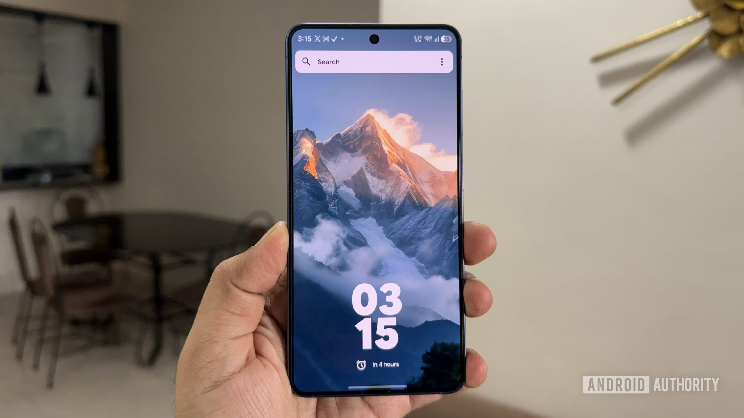 Galaxy phone in hand showing Kvaesitso launcher home screen