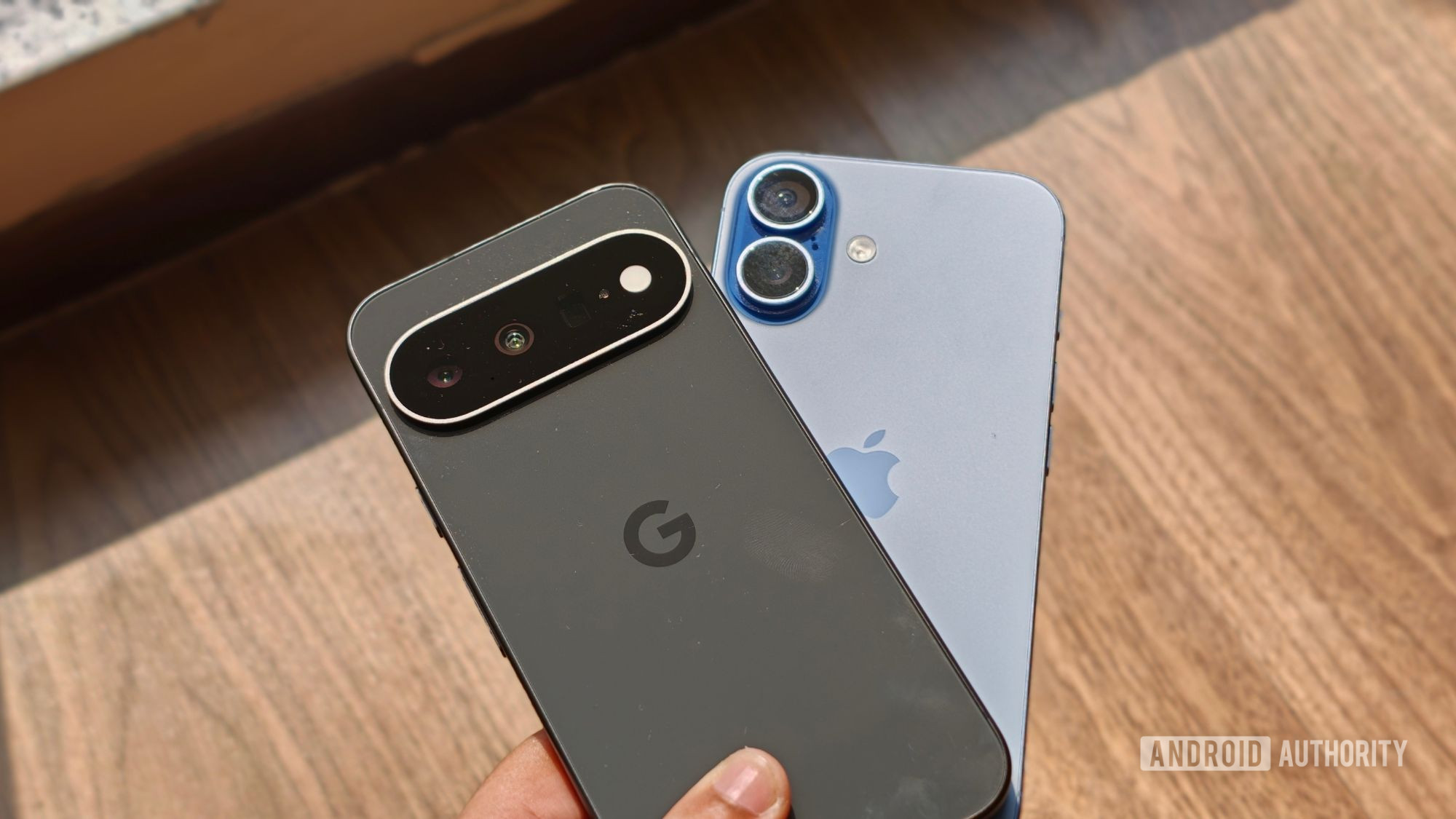 Pixel 11 over iPhone 17 in a person's hand Pixel 11 over iPhone 17 in a person's hand