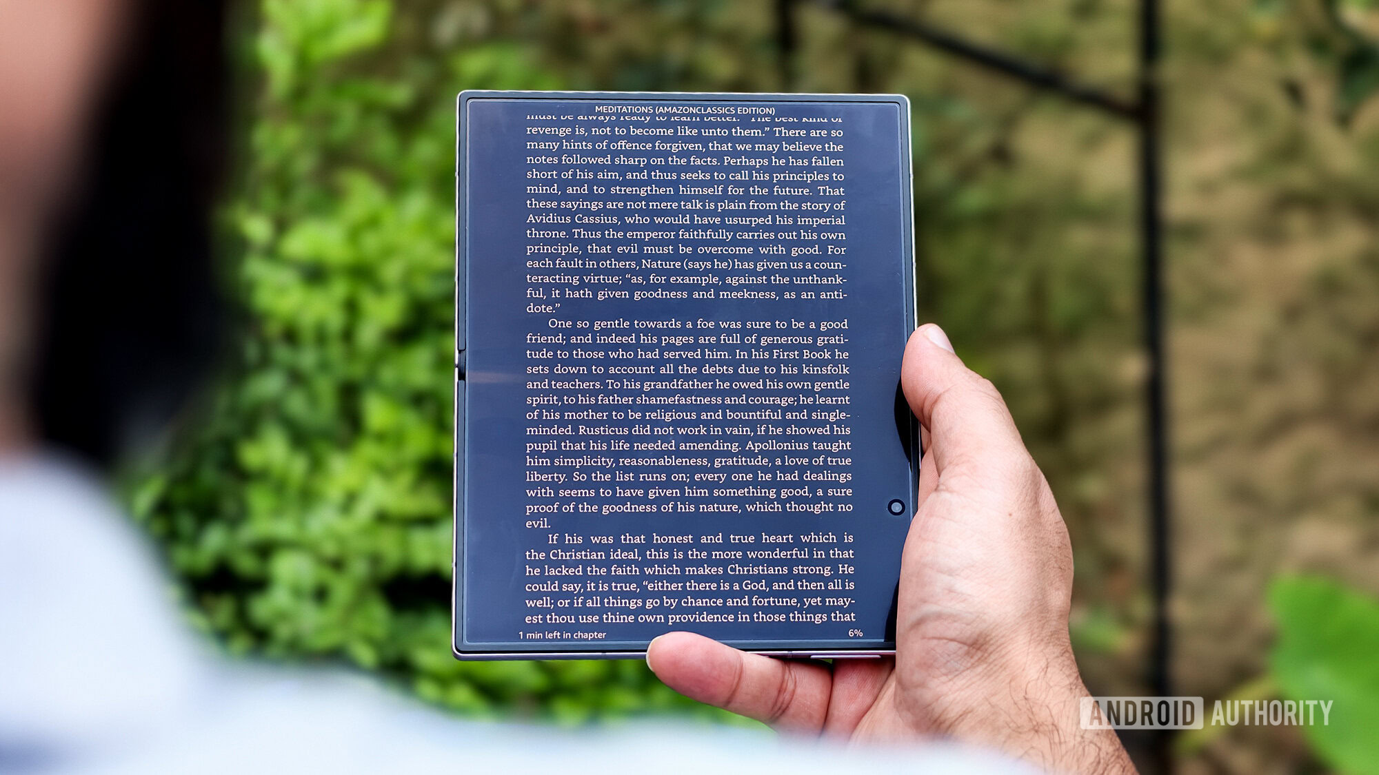 Samsung Galaxy Z Fold in hand reading outdoor Samsung Galaxy Z Fold in hand reading outdoor
