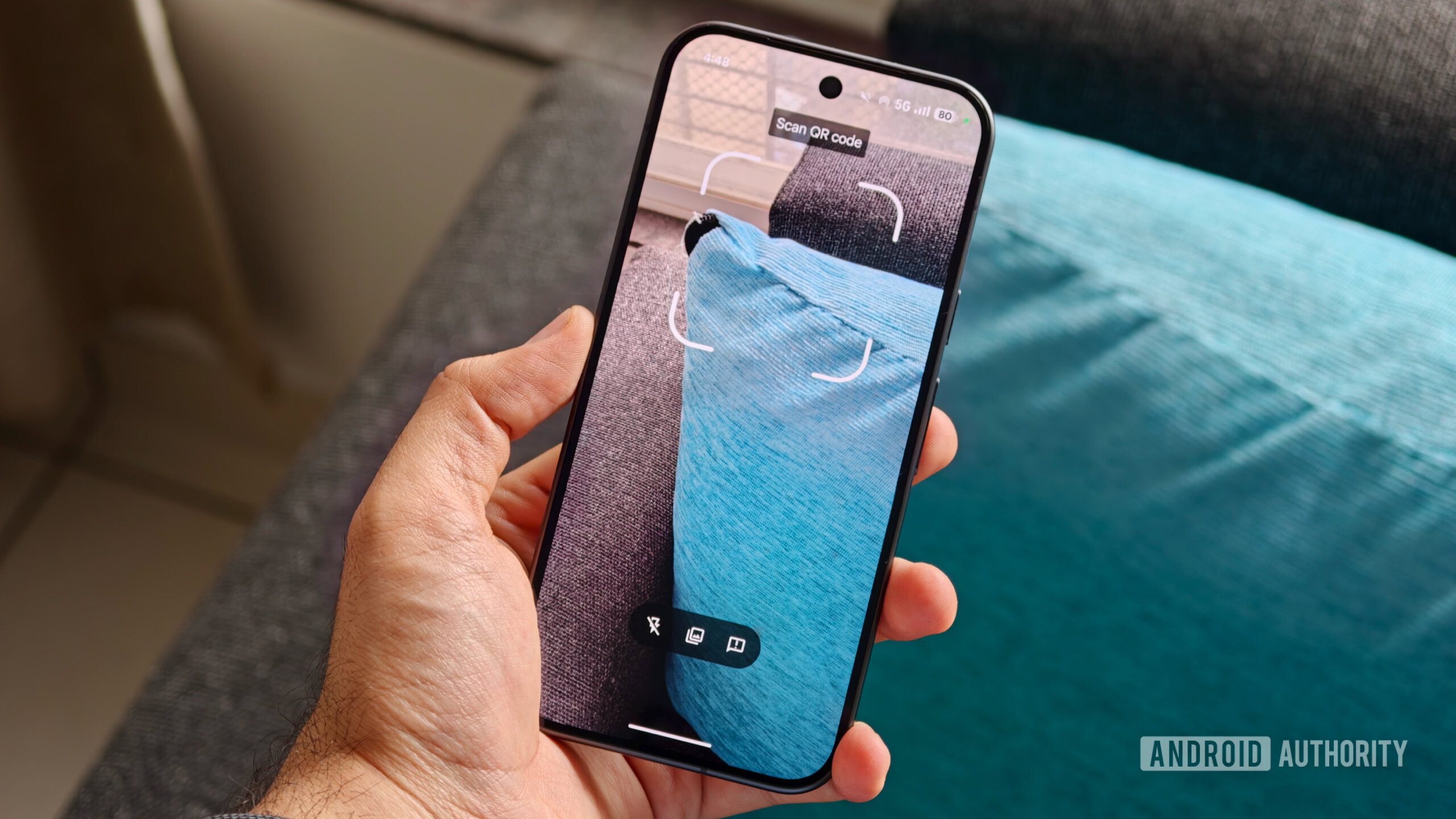 android quick settings tiles 4 A person holding a phone with the built-in "Scan QR code" camera viewfinder active