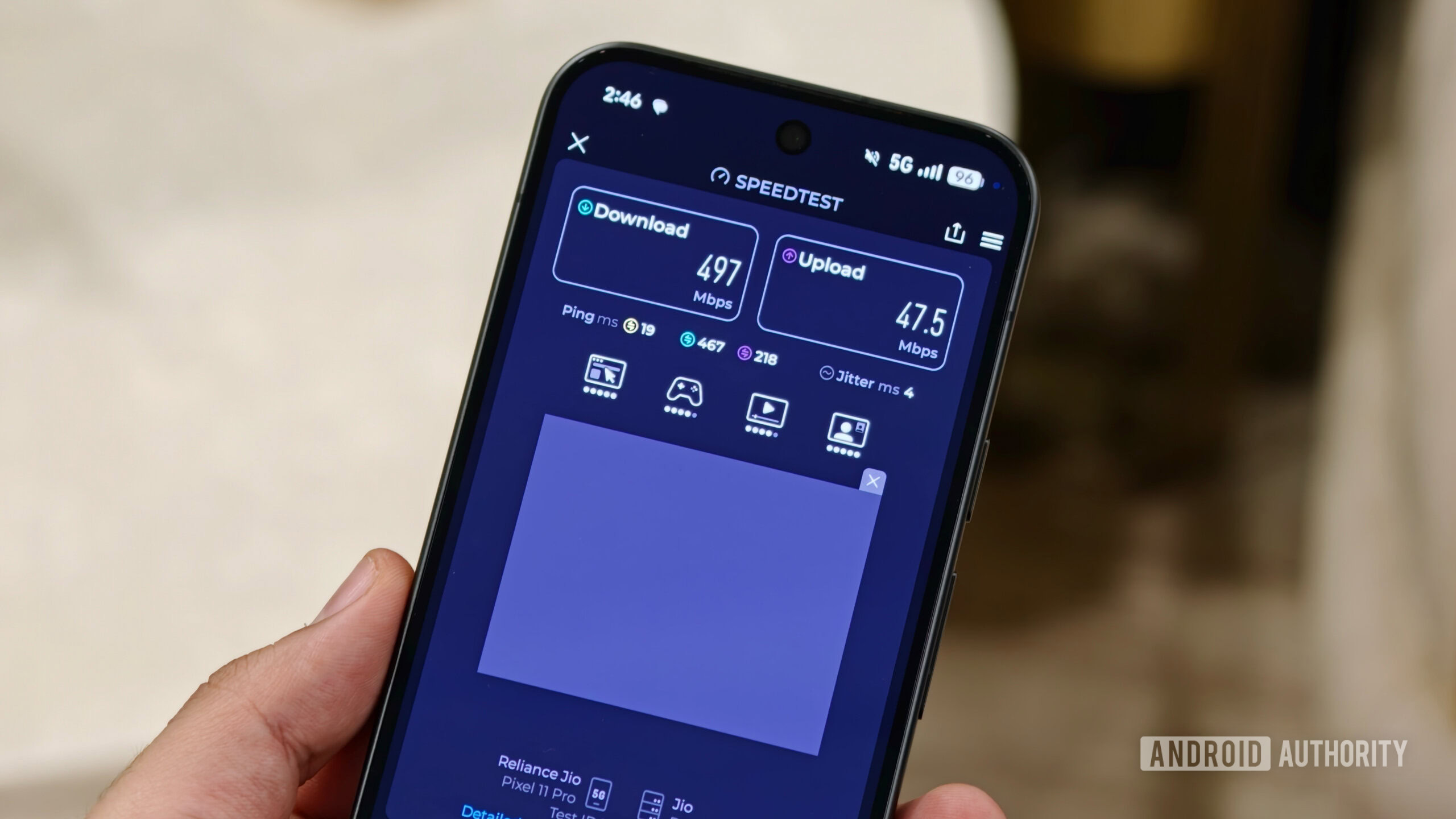 A hand holding a Google Pixel 11 Pro running a 5G Speedtest