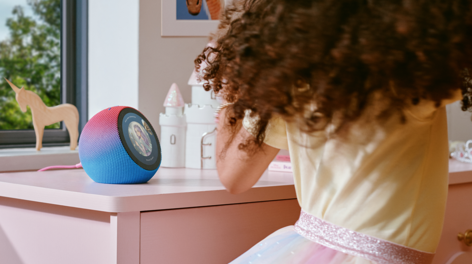 Kid at desk with Amazon Kids Echo Time next to them Amazon Kids Echo Time