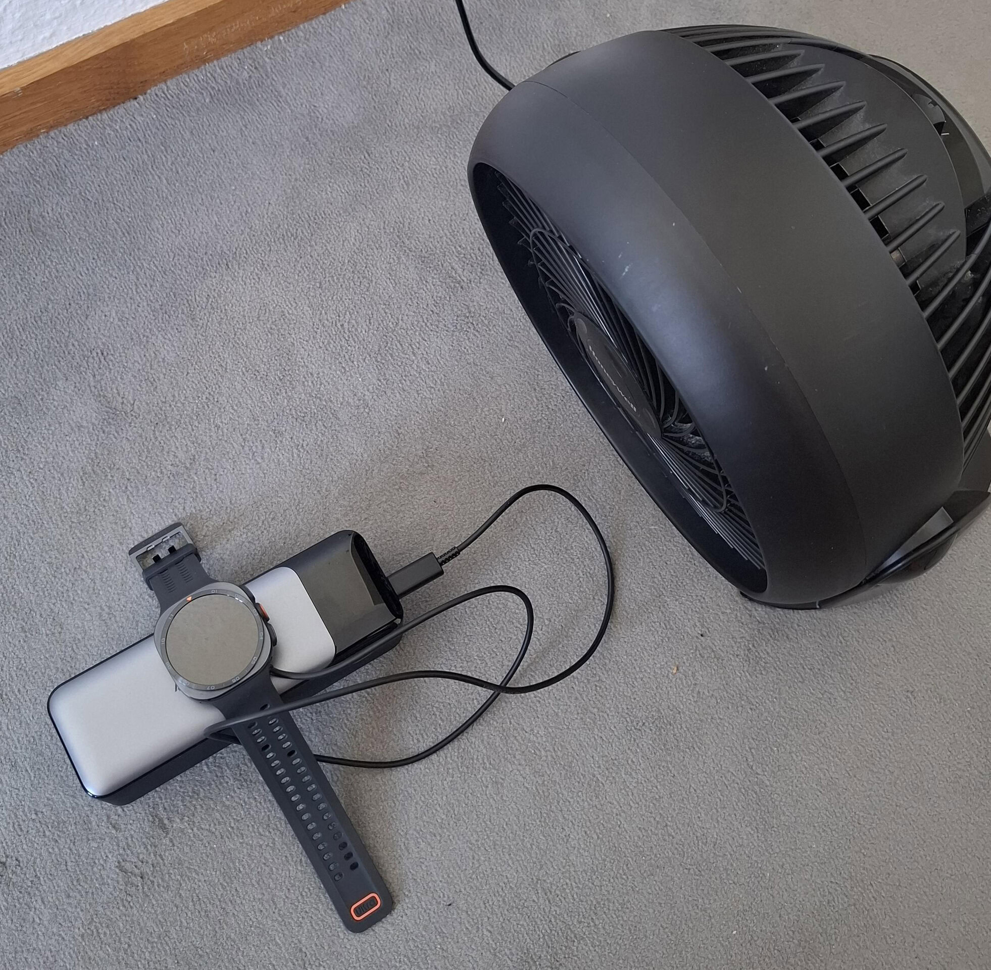 Charging Galaxy Watch Ultra 2 in front of a fan