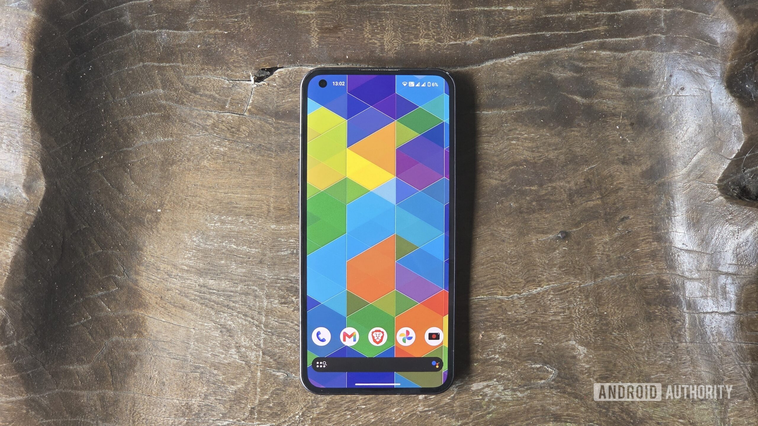 Nothing Phone with Nova Launcher home screen on wood Nothing Phone with Nova Launcher home screen on wood