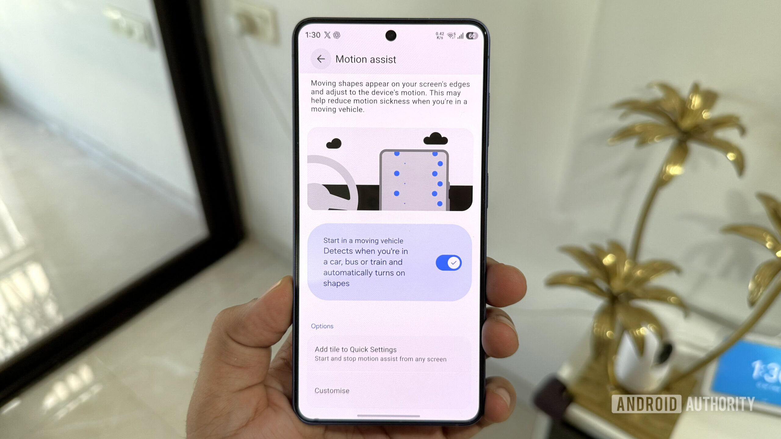 Samsung phone in hand showing Motion Assist menu